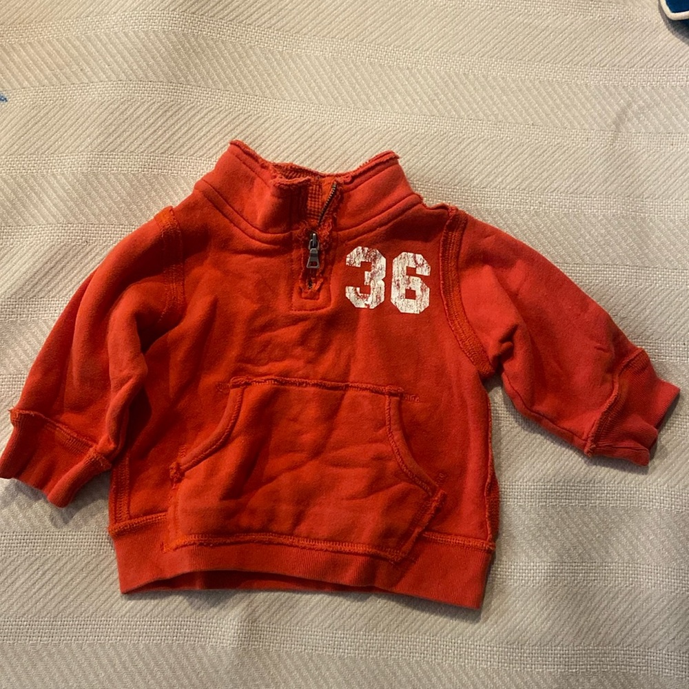 Orange, half zip sweatshirt . 24 months Cat Friendly home. Very good condition.
